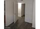 Bedroom with a open doorway, neutral walls and modern gray flooring at 1608 N Torrey Pines Dr # 103, Las Vegas, NV 89108