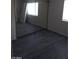 Bedroom with mirrored closet reflecting window and modern gray flooring at 1608 N Torrey Pines Dr # 103, Las Vegas, NV 89108