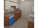 Functional kitchen with granite countertops, white upper cabinets, and a blue dishwasher at 1608 N Torrey Pines Dr # 103, Las Vegas, NV 89108