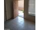 Bright living space with tiled flooring and entry to the front porch at 1608 N Torrey Pines Dr # 103, Las Vegas, NV 89108