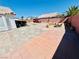 Expansive backyard featuring unique landscaping, a built-in grill, and a spacious brick-paved patio at 1860 Banaba Ln, Las Vegas, NV 89156