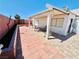 Expansive backyard featuring unique landscaping and a spacious brick-paved patio, perfect for outdoor living at 1860 Banaba Ln, Las Vegas, NV 89156