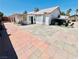 Expansive backyard featuring a covered patio, lush landscaping, and plenty of space for outdoor entertaining at 1860 Banaba Ln, Las Vegas, NV 89156