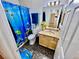 Cozy bathroom featuring vanity with floral decor, fish-themed shower curtain and accessories at 1860 Banaba Ln, Las Vegas, NV 89156