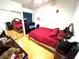 Bedroom featuring mirrored closet and a comfortable red bed set at 1860 Banaba Ln, Las Vegas, NV 89156
