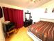 Bright bedroom with wood floors, stylish decor, and a ceiling fan at 1860 Banaba Ln, Las Vegas, NV 89156