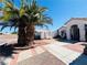 Charming front yard showcasing a well-maintained landscape, mature trees, and a walkway to the front door at 1860 Banaba Ln, Las Vegas, NV 89156