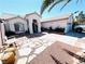 Charming single-story home with stone pathway leading to front door, desert landscaping, and an arched entryway at 1860 Banaba Ln, Las Vegas, NV 89156
