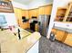 Well-lit kitchen with stainless steel appliances, wooden cabinetry, and granite countertops at 1860 Banaba Ln, Las Vegas, NV 89156