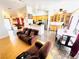 Open-concept living room and kitchen area with hardwood and tile flooring, and abundant natural light at 1860 Banaba Ln, Las Vegas, NV 89156