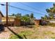 Backyard featuring grass, a palm tree, a shed, and a chain link fence at 201 Cervantes St, Las Vegas, NV 89101