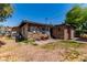 Backyard featuring stone walls, grass, a red cart, and an external building at 201 Cervantes St, Las Vegas, NV 89101