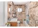 Bathroom featuring stone-look walls, white sink, toilet, and a shower-tub combination at 201 Cervantes St, Las Vegas, NV 89101