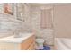 Bathroom features stone accent wall, tile flooring, shower and bath at 201 Cervantes St, Las Vegas, NV 89101