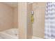 Bathroom featuring a tile shower with blue and white striped curtain and a white tub at 201 Cervantes St, Las Vegas, NV 89101
