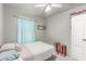 Cozy bedroom with tile floors, a ceiling fan, and a light blue curtain at 201 Cervantes St, Las Vegas, NV 89101