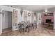 Well-lit dining space with tiled floors and decorative butterfly wall art, and a brick fireplace nearby at 201 Cervantes St, Las Vegas, NV 89101