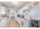 Charming kitchen featuring white cabinetry, tile flooring, and appliances at 201 Cervantes St, Las Vegas, NV 89101