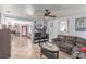 Comfortable living room features tile flooring, ceiling fan and access to the brick fireplace in the home at 201 Cervantes St, Las Vegas, NV 89101