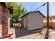 Backyard featuring an external shed with a white door and a paved path at 201 Cervantes St, Las Vegas, NV 89101