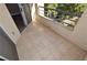 Tiled balcony with railing and views of mature trees and partial landscaping at 220 E Flamingo Rd # 116, Las Vegas, NV 89169