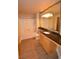 Well-lit bathroom with updated vanity featuring granite counters, single sink, and wood cabinets at 220 E Flamingo Rd # 116, Las Vegas, NV 89169