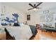 Bright bedroom with a creative wall mural, wood floors, and a window view at 2231 S Tioga Way, Las Vegas, NV 89117