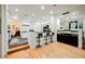 A kitchen bar featuring seating for three with dark counters, light wood floors and modern cabinetry at 2231 S Tioga Way, Las Vegas, NV 89117