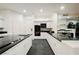 Bright kitchen featuring black countertops, stainless steel appliances, and ample cabinet space for culinary enthusiasts at 2231 S Tioga Way, Las Vegas, NV 89117