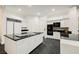 Spacious kitchen with sleek black countertops, modern appliances, and ample cabinet space for storage and meal preparation at 2231 S Tioga Way, Las Vegas, NV 89117
