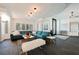 Bright living room with teal sofa, decorative rugs and a modern coffee table at 2231 S Tioga Way, Las Vegas, NV 89117