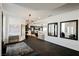 Open-concept living space with tiled floors, a chandelier, and multiple mirrors reflecting natural light at 2231 S Tioga Way, Las Vegas, NV 89117