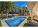 Inviting backyard oasis with a sparkling pool, covered patio, and lush landscaping, perfect for outdoor entertaining at 2231 S Tioga Way, Las Vegas, NV 89117