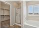 Bathroom featuring a separate glass shower, walk-in closet, and soaking tub near window at 2284 Carambala Ln, Henderson, NV 89044