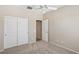 Neutral bedroom featuring carpeted floors, a ceiling fan, and a closet with sliding doors at 2284 Carambala Ln, Henderson, NV 89044