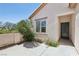 Exterior view of the home's front door and side courtyard with mature landscaping at 2284 Carambala Ln, Henderson, NV 89044