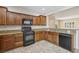 Updated kitchen showcasing wood cabinets, granite countertops and modern appliances at 2284 Carambala Ln, Henderson, NV 89044
