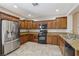 Well-equipped kitchen featuring wood cabinets, stainless steel appliances and granite counters at 2284 Carambala Ln, Henderson, NV 89044