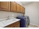 Functional laundry room equipped with modern appliances and ample cabinet space for convenience at 2284 Carambala Ln, Henderson, NV 89044