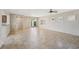 Spacious living room featuring tile flooring and a sliding glass door to the backyard at 2284 Carambala Ln, Henderson, NV 89044