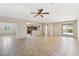 Open-concept living room with tile flooring, ceiling fan, and backyard access at 2284 Carambala Ln, Henderson, NV 89044