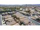 Wide aerial shot of a neighborhood with uniform houses, green spaces, and community pool at 236 Dog Leg Dr, Las Vegas, NV 89148