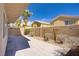 Stamped concrete patio, with block wall, rock beds, desert landscaping, and palm trees in the backyard at 236 Dog Leg Dr, Las Vegas, NV 89148