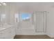 Bathroom featuring a soaking tub and shower with bright sunlight from the window at 236 Dog Leg Dr, Las Vegas, NV 89148