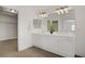 Bathroom featuring a double vanity sink with white cabinets and a walk-in closet at 236 Dog Leg Dr, Las Vegas, NV 89148