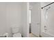 Bathroom featuring a toilet, shower-tub combination, and neutral tile flooring at 236 Dog Leg Dr, Las Vegas, NV 89148