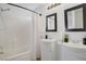 Bright bathroom featuring double sinks, framed mirrors, and a shower-tub combination at 236 Dog Leg Dr, Las Vegas, NV 89148