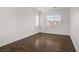Bright bedroom showcasing laminate flooring and natural light from dual windows at 236 Dog Leg Dr, Las Vegas, NV 89148