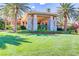 Clubhouse entrance features stone pillars, lush landscaping, and palm tree accents at 236 Dog Leg Dr, Las Vegas, NV 89148