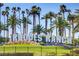 The Rhodes Ranch community sign, surrounded by mature palm trees and manicured lawns at 236 Dog Leg Dr, Las Vegas, NV 89148